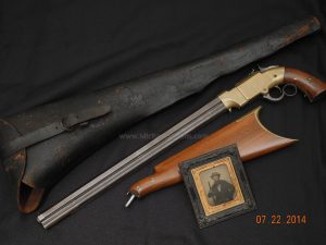 An antique Volcanic lever action rifle displayed in a museum setting, showcasing its early design and historical significance.