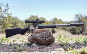 A long-barreled lever action rifle displayed in an open field, emphasizing its use for long-range shooting and precision.