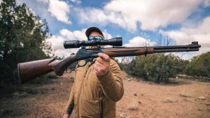 A traditional lever action rifle with a classic wooden stock, showcasing its sleek design and heritage appeal.